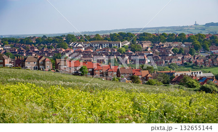 Whitby cityscape overlooking rooftops and green fields in North York Moors National Park 132655144