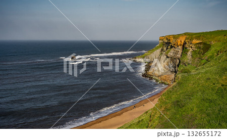 Scenic view of Whitby cliffs meeting North Sea in North York Moors National Park 132655172