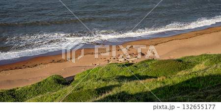 Gentle waves washing the sandy shore of Whitby in North York Moors National Park 132655177