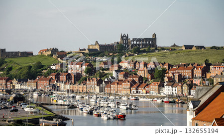 Whitby harbor with boats and Whitby Abbey dominating the skyline in North York Moors National Park Whitby harbor with boats and Whitby Abbey dominating the skyline in North York Moors National Park 132655194