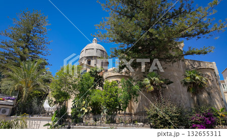 Norman Cathedral rising over lush vegetation in Tropea, Calabria 132655311