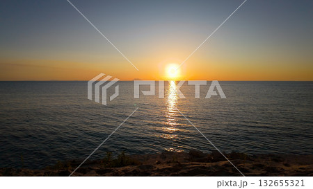 Stromboli Volcano emerging from the Tyrrhenian Sea at sunset, seen from Tropea, Calabria, Italy 132655321