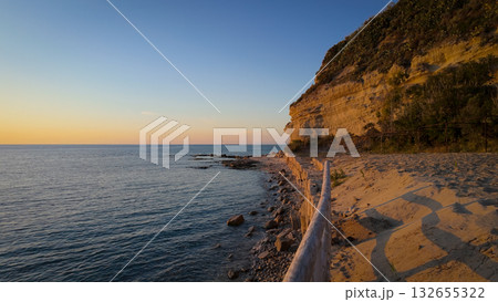 Wooden fence running along the beach at sunset in Tropea, Calabria, Italy 132655322