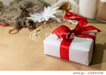 Side view of homemade christmas gift with natural elements on brown paper Side view of homemade christmas gift with natural elements on brown paper 132655546
