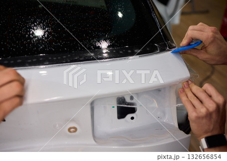 Applying a Protective Film on the Surface of Your Car for Enhanced Durability and Shine 132656854