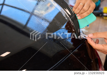 Applying a Protective Film on the Surface of Your Car for Enhanced Durability and Shine 132656920