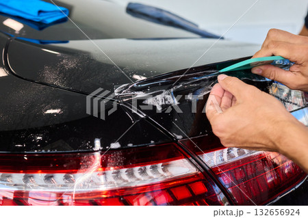 Applying a Protective Film on the Surface of Your Car for Enhanced Durability and Shine Applying a Protective Film on the Surface of Your Car for Enhanced Durability and Shine 132656924