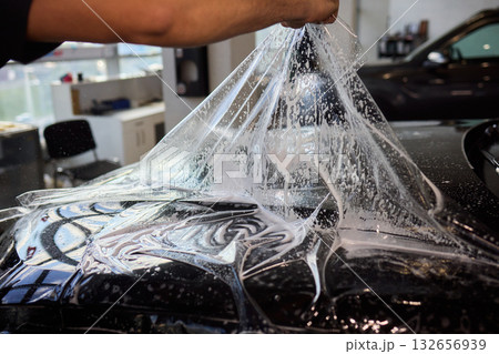 Applying a Protective Film on the Surface of Your Car for Enhanced Durability and Shine Applying a Protective Film on the Surface of Your Car for Enhanced Durability and Shine 132656939