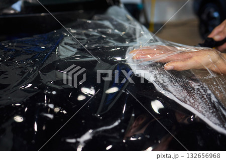 Applying a Protective Film on the Surface of Your Car for Enhanced Durability and Shine 132656968