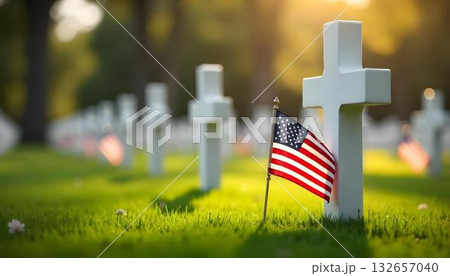 American flags honor fallen heroes at a cemetery, with white crosses in the background. A single flag in the foreground symbolizes remembrance on Patriot DayMemorial Day. Never forget 132657040