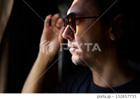 Nighttime artistic portrait, Creative director by window scene, Moody cinematic image of nighttime scene, Reflective lenses capturing introspective moments at night Nighttime artistic portrait, Creative director by window scene, Moody cinematic image of nighttime scene, Reflective lenses capturing introspective moments at night 132657735