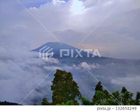 Majestic Volcano Peak Emerging from Sea of Clouds Majestic Volcano Peak Emerging from Sea of Clouds 132658249