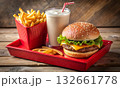 Fast-food meal with a cheeseburger, French fries, and a milkshake 132661778