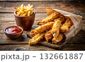 Crispy chicken tenders served with French fries and ketchup 132661887