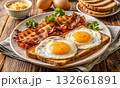 Classic fried eggs with crispy bacon and toast served hot 132661891