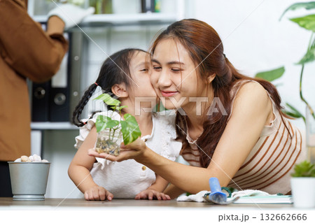 Family Gardening and Sustainability. A mother and daughter bonding over plant care at home. Family Gardening and Sustainability. A mother and daughter bonding over plant care at home. 132662666