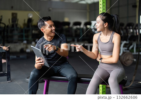Personal Trainer and Client Engaging in Fitness Discussion Personal Trainer and Client Engaging in Fitness Discussion 132662686