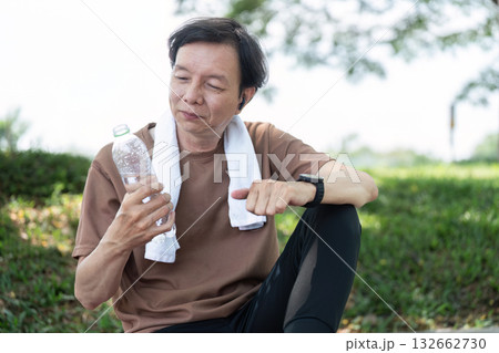 Wellness in Yoga: Senior man enjoying hydration after practice Wellness in Yoga: Senior man enjoying hydration after practice 132662730