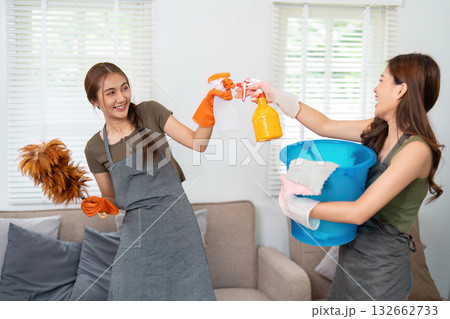 Cleaning creativity: Women playfully engaging in housework Cleaning creativity: Women playfully engaging in housework 132662733