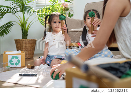 Family Fun and Environmental Awareness. Kids crafting trees from recycled materials. Family Fun and Environmental Awareness. Kids crafting trees from recycled materials. 132662818