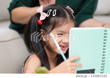 Back to School and Learning. A girl joyfully shares her drawing, excited for the new school year. 132663102