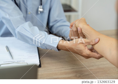 Doctor checking patient's wrist for pulse and health assessment Doctor checking patient's wrist for pulse and health assessment 132663129