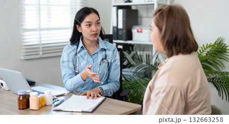 Consultation and Patient Support. A general practitioner providing guidance to a patient during a medical consultation. 132663258