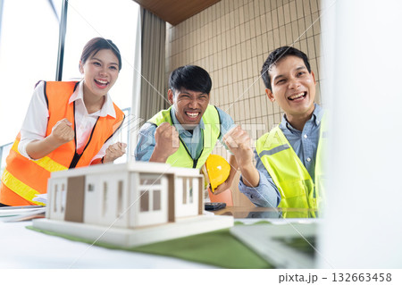 Engineers celebrating completion of sustainable construction model 132663458