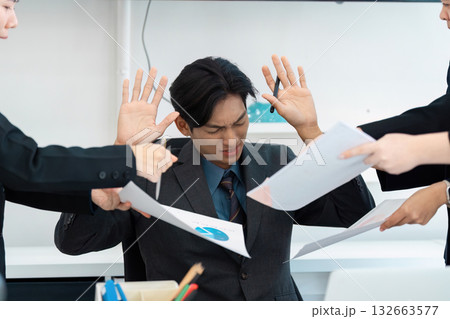 Stressed business professional overwhelmed by reports and discussions in an office. Stressed business professional overwhelmed by reports and discussions in an office. 132663577