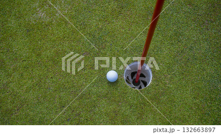 Golf ball is on a green lawn in a beautiful golf course with morning sunshine. 132663897