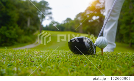 Golfer playing golf in the evening golf course, on sun set evening time. Golfer playing golf in the evening golf course, on sun set evening time. 132663905
