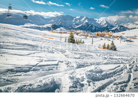 Ski tracks and deep fresh snow on the slope, France 132664670