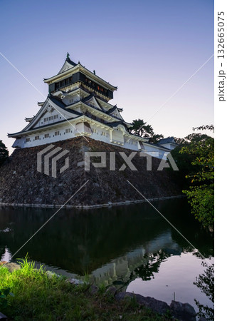Kokura Castle by pond with skyline reflection at dusk, Kitakyushu Kokura Castle by pond with skyline reflection at dusk, Kitakyushu 132665075