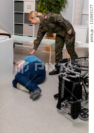 Military Personnel Assisting an Injured Individual During Controlled Training Exercises Military Personnel Assisting an Injured Individual During Controlled Training Exercises 132665177
