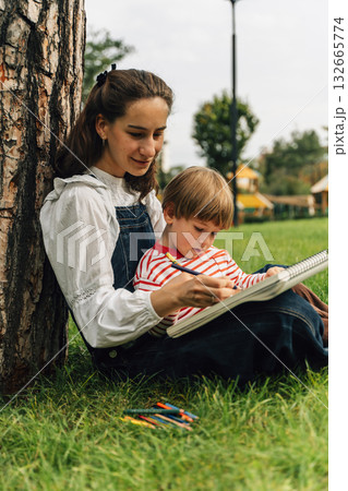 Mother and Toddler Drawing Together in a Summer Park. Parenting and Childhood Development Concept 132665774