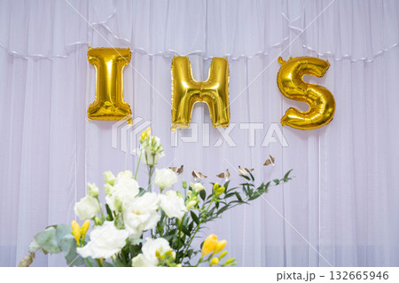 Gold IHS Balloons at a Beautiful Celebration Enhanced with a Lovely Floral Arrangement 132665946