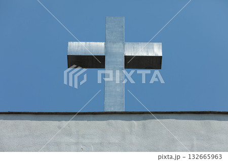 A Silver Cross Set Against a Beautiful and Clear Blue Sky Evokes Deep Spiritual Feelings A Silver Cross Set Against a Beautiful and Clear Blue Sky Evokes Deep Spiritual Feelings 132665963