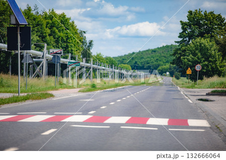 A peaceful rural road with a speed bump and traffic signs, highlighting countryside tranquility 132666064