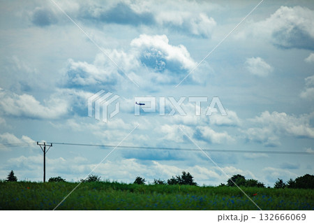 A Mysterious Object Has Been Spotted in the Sky Above the Green Fields of Agriculture 132666069