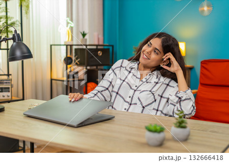 Indian woman closes laptop satisfied project finished relaxes big calm relief enjoying leisure break 132666418