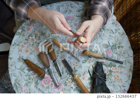 Man Carving Wood by Hand. Traditional Woodworking and Craftsmanship Tools 132666437