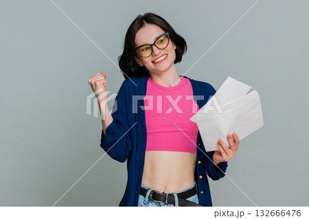 Young woman opening letter gradually smiling more expressing joyful news lottery win test results Young woman opening letter gradually smiling more expressing joyful news lottery win test results 132666476