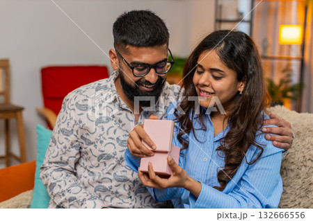 Indian family couple man woman reacting to surprise gift, emotional excited moment of happiness 132666556