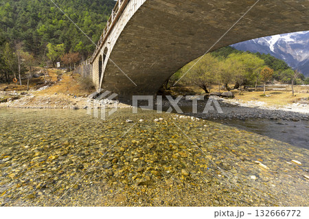 Lijiang, China - April 10, 2024 : A view of a walkway over the lake in Blue Moon Valley in Lijiang, China on April 10, 2024. Lijiang, China - April 10, 2024 : A view of a walkway over the lake in Blue Moon Valley in Lijiang, China on April 10, 2024. 132666772