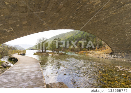 Lijiang, China - April 10, 2024 : A view of a walkway over the lake in Blue Moon Valley in Lijiang, China on April 10, 2024. Lijiang, China - April 10, 2024 : A view of a walkway over the lake in Blue Moon Valley in Lijiang, China on April 10, 2024. 132666775