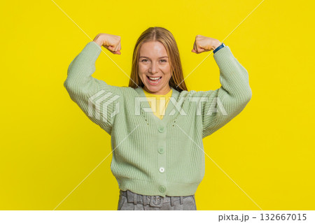 Happy woman looking confident showing biceps feeling power strength to fight for rights success win Happy woman looking confident showing biceps feeling power strength to fight for rights success win 132667015