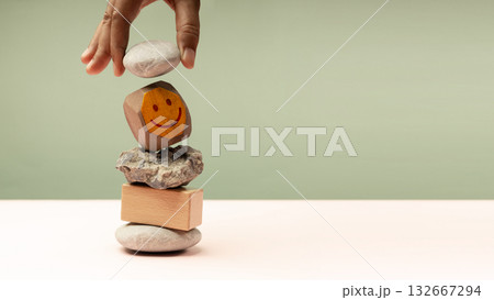 Enjoying Life Concept. Harmony and Positive Mind. Hand Setting Natural Pebble Stone, Cement and Wood block Stack Enjoying Life Concept. Harmony and Positive Mind. Hand Setting Natural Pebble Stone, Cement and Wood block Stack 132667294