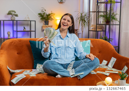 Successful happy rich business woman counting money cheering up with high profits lottery game win Successful happy rich business woman counting money cheering up with high profits lottery game win 132667465