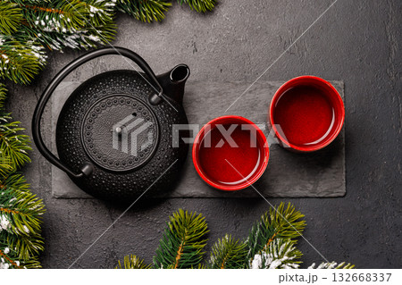 Christmas tea setting with teapot, cups, and fir tree branches Christmas tea setting with teapot, cups, and fir tree branches 132668337