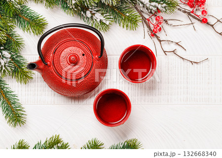 Christmas tea setting with teapot, cups, and fir tree branches Christmas tea setting with teapot, cups, and fir tree branches 132668340